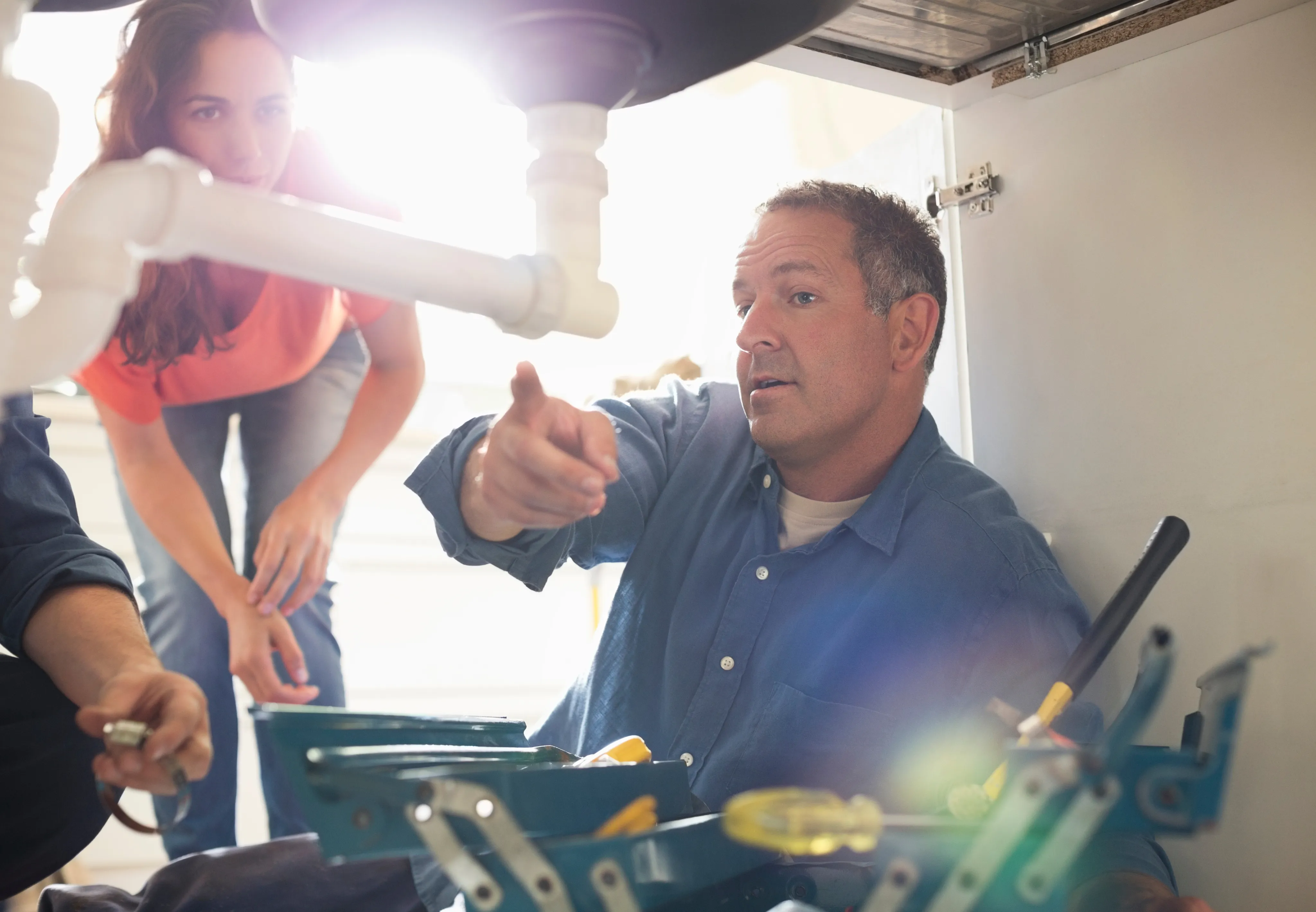 Plumber performing a commercial plumbing assessment